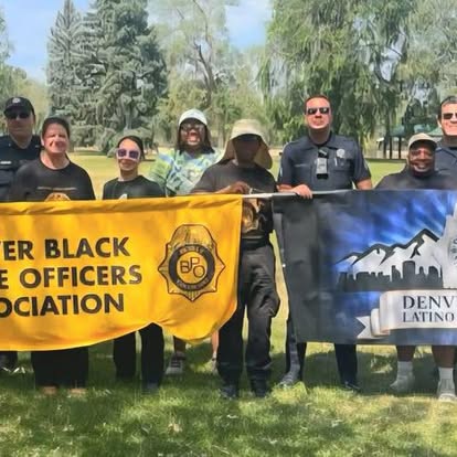 BPO members holding the Denver Black Police Officers Association banner outdoors