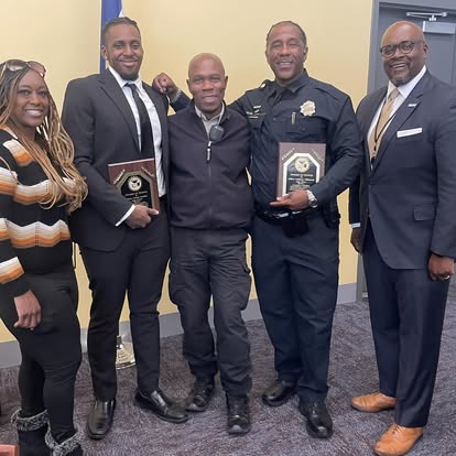 Members holding award plaques